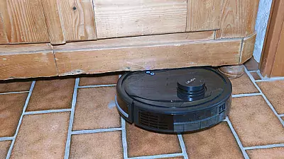 Saugroboter hat sich unter einem Schrank verkeilt